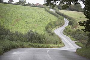 Road Winding Its Way Through The Countryside