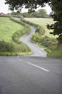 Road Winding Its Way Through The Countryside