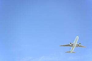Commercial Airplane Flying Against A Blue Sky