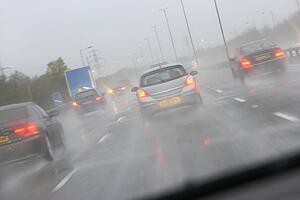 Cars Driving On A Rain Slicked Highway