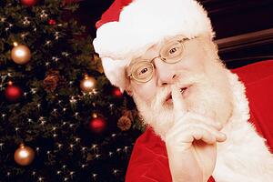 Santa Claus with finger to lips