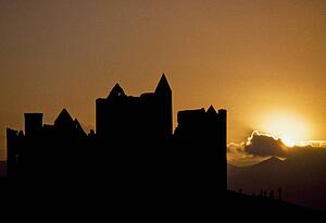 Cashel Rock, Co Tipperary, Ireland; Cashel Rock silhouetted against majestic sunset
