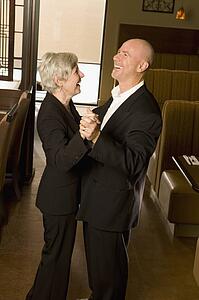 Senior couple dancing and laughing together
