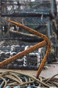 East Riding, Yorkshire, England; Rusty anchor and lobster pots on the seafront
