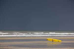 East Riding, Yorkshire, England; Surf rescue board lying on the foreshore