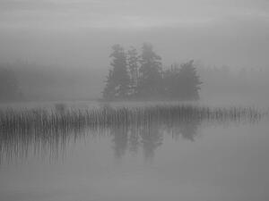 Lake of the Woods, Ontario, Canada; Mist rises over lake