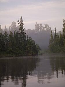 Lake of the Woods, Ontario, Canada; Mist rises over lake