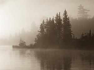 Lake of the Woods, Ontario, Canada; Mist rises over lake