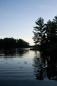 Lake of the Woods, Ontario, Canada; Sunset over placid lake