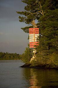 Lake of the Woods, Ontario, Canada; Red and white nautical sign on lake