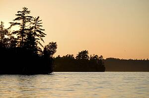 Lake of the Woods, Ontario, Canada; Majestic sunset casting glow over lake