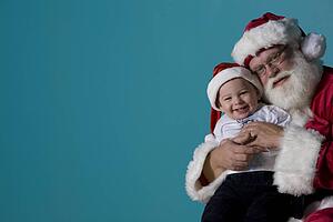 Portrait of Santa with a baby