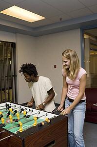 Teenagers playing foosball