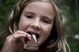 Girl eating ice cream bar, Lake of the Woods, Ontario, Canada