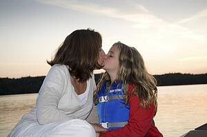 Mother and daughter kiss, Lake of the Woods, Ontario, Canada