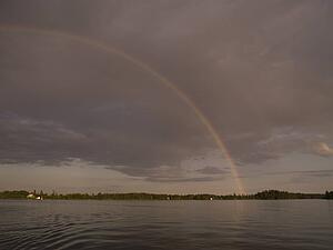 Rainbow over lake shoreline, Lake of the Woods, Ontario, Canada
