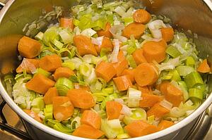 Carrots, leaks and onions browning as basis for vegetable soup 