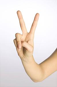 Woman's hand making a peace sign
