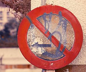 Old graffiti covered 'No Parking To Left' sign