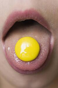 Close-up of mouth with candy on tongue