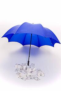 Umbrella covering piles of money