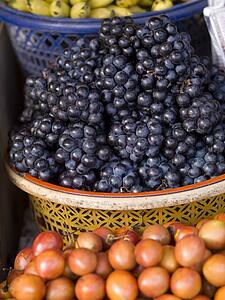 Grapes and Mangosteens, Bali, Asia; Baskets of fruits in a market