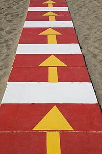La Carihuela Torremolinos, Costa del Sol, Spain; Arrows on pathway