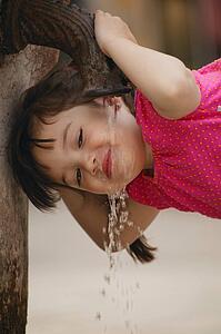 Girl drinking from water fountain