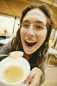 Woman eats soup