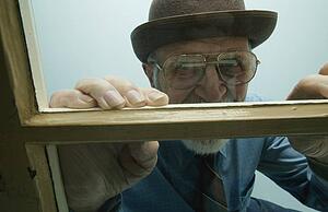 Man looks out window