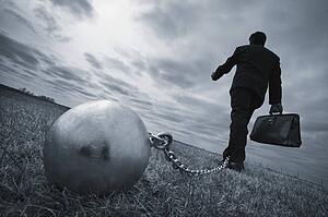 Businessman with ball and chain