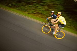 Two people racing on bikes