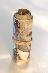 Roll of Canadian one hundred dollar bills