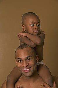 Upset son on father's shoulders