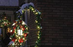 Snow covered Christmas decorations outside a house