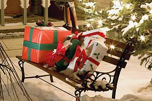 Wrapped presents sitting on a park bench outside