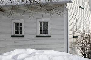 Snow piling high in a backyard