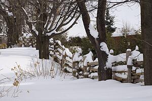 Wooden fence covered in snow