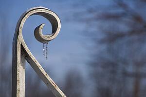 Icicles hang from an iron gate