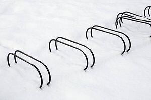 Bicycle racks partially buried in snow