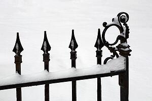 Iron gate covered in snow