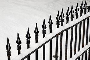 Iron gate covered in snow