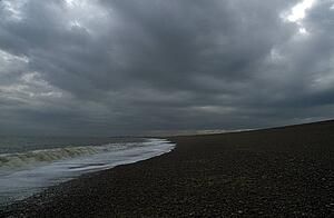 East Anglia, England, United Kingdom; Sea water rolling up a gravel beach