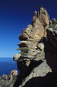 Corsica, France; Rock formation on a mountain above the sea