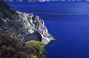 Oregon, USA; Cliffs and clear water in Crater Lake National Park