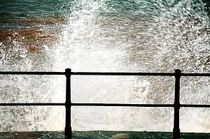 Sidmouth, Devon, England, United Kingdom; Waves crashing against the seawall