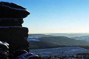 Derbyshire, England, United Kingdom; Snow covered rock formations in a national park. 