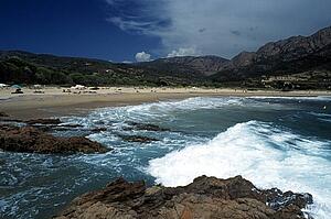 Corsica, France; People enjoying the sun on a Mediterranean beach