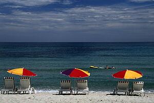 Corsica, France; Lounge chairs and sun umbrellas on a Mediterranean beach