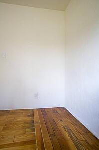 Empty room with wooden floors and white walls